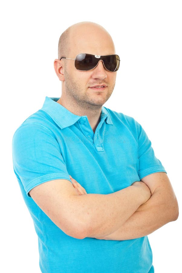 Bald man in mirror sunglasses. A beautiful tanned man on vacation, smiling. Port