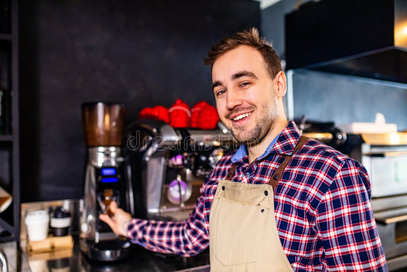 Handsome Barista Preparing Cup of Coffee for Customer and Looking at