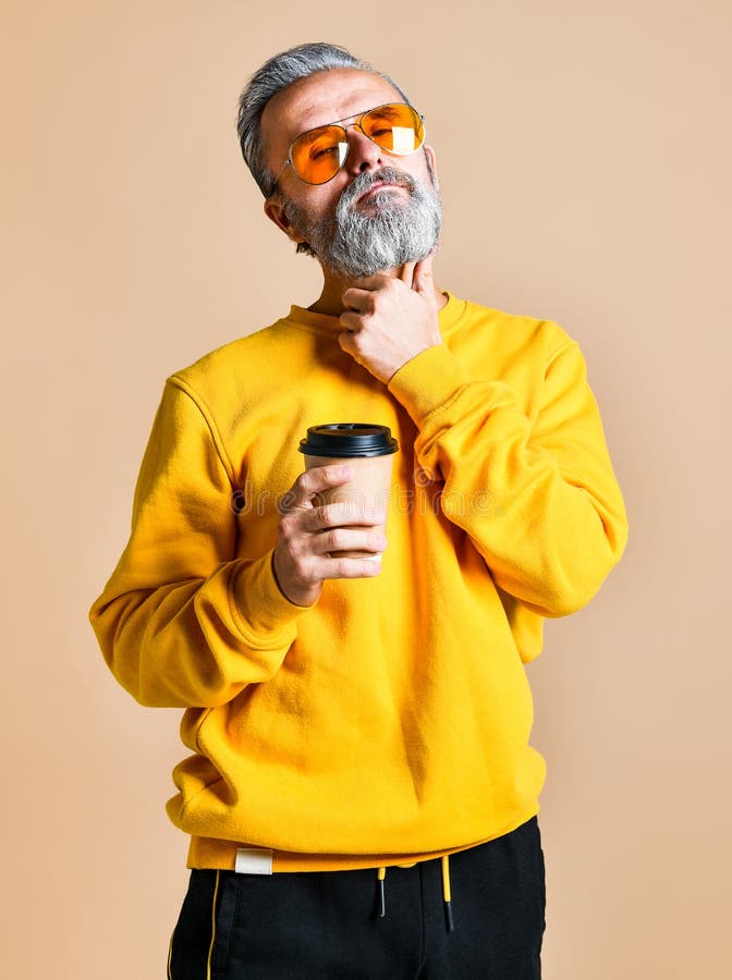 Handsome bearded man with paper cup of morning coffee