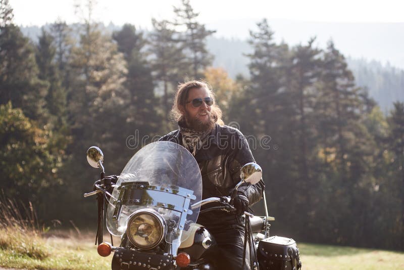 Bearded Biker with Long Hair in Black Leather Jacket and Sunglasses Sitting  on Modern Motorcycle. Stock Photo - Image of black, beard: 138334618