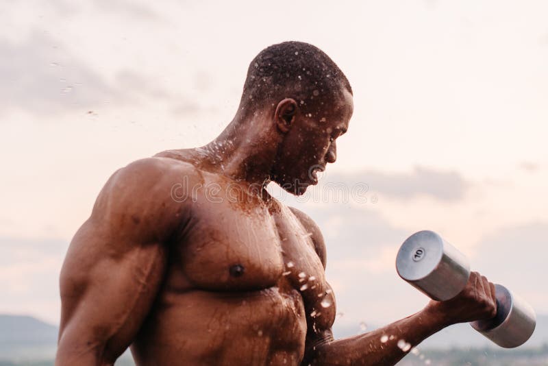 Handsome Black African American Muscular Man Lifting Dumbbel