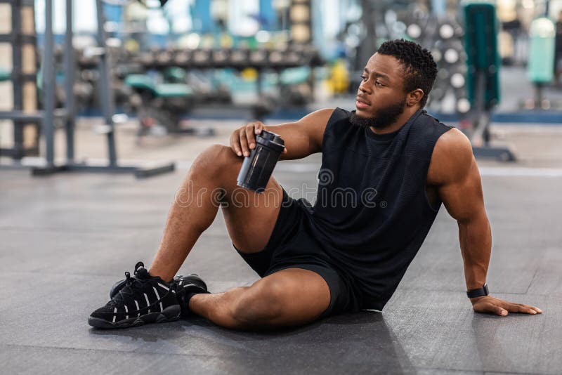 Handsome Black Athlete Training Arms with Dumbbells at Gym Stock
