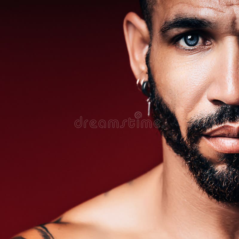 Handsome blue-eyed Cuban or Latino with beard looks straight into camera. Part of face of man 30-40 years old close-up.