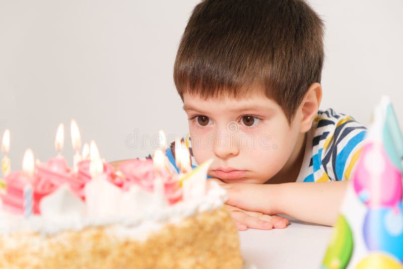 A Handsome Boy Celebrates a Birthday, Sits in Front of a Cake with