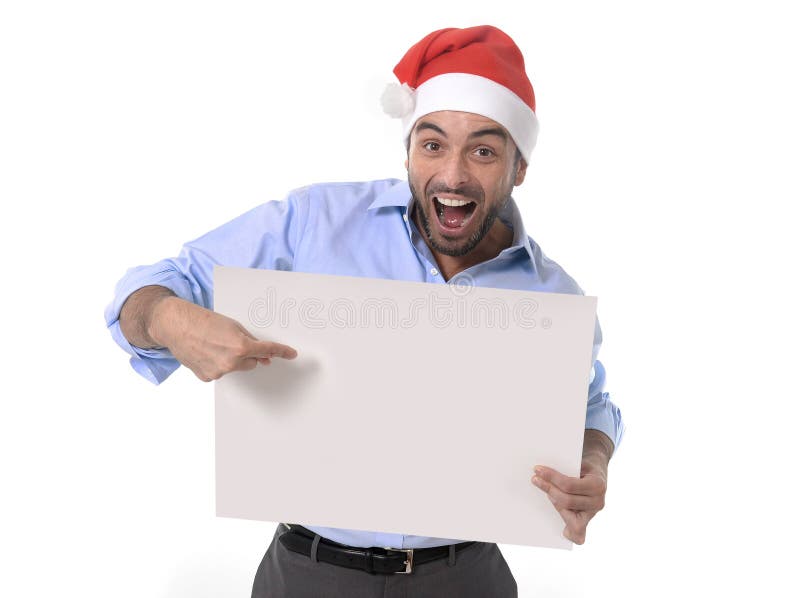 Handsome business man in santa christmas hat pointing blank billboard