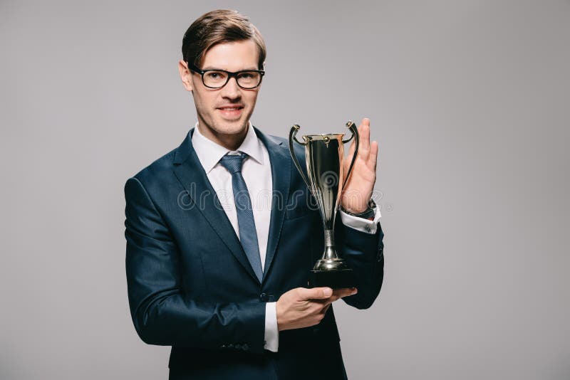 Handsome Businessman Holding Trophy in Hands Isolated Stock Image