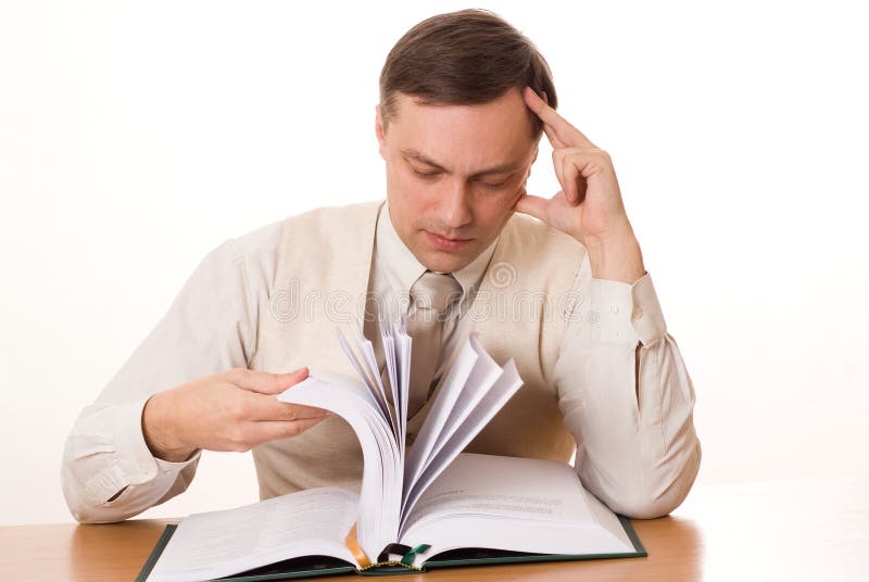 Handsome businessman reading a book on white