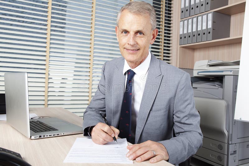 Handsome businessman reads the agreement royalty free stock photo