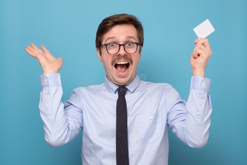 Handsome caucasian young man with white card royalty free stock image Handsome caucasian young man with white card royalty free stock image
