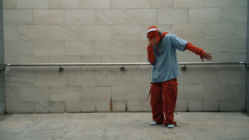 Handsome choreographer practice street dance in gray background. Sprightly.