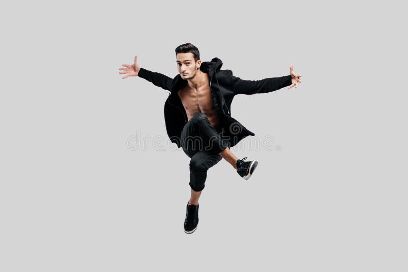 Hip Hop Dancer Nude Girl - Handsome Dancer of Street Dancing Dressed in Black Pants and a Sweatshirt  on a Naked Torso Jumps and Spreads His Arms To Stock Image - Image of  active, performer: 140597725