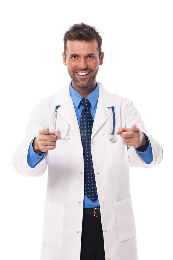 Smiling male doctor pointing at you. Smiling male doctor pointing at you