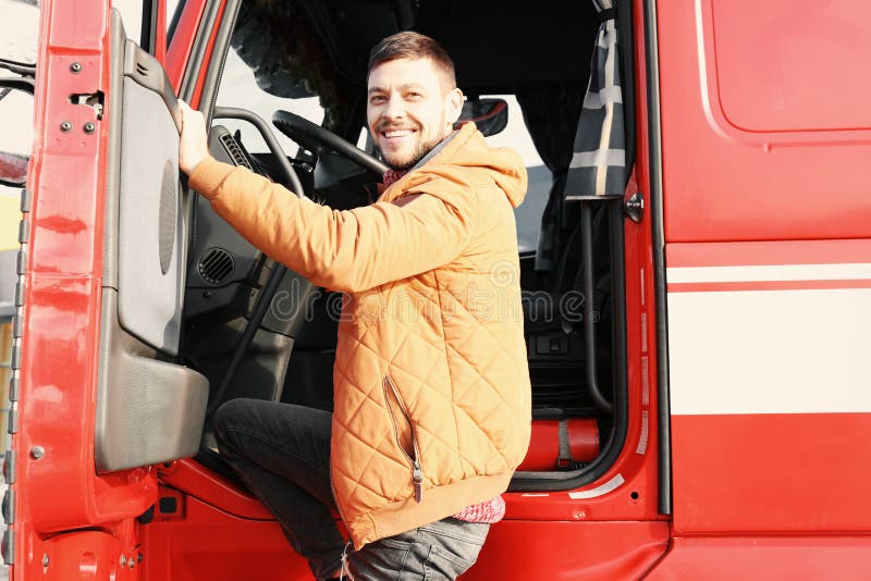Handsome driver near big modern truck royalty free stock photos Handsome driver near big modern truck royalty free stock photos