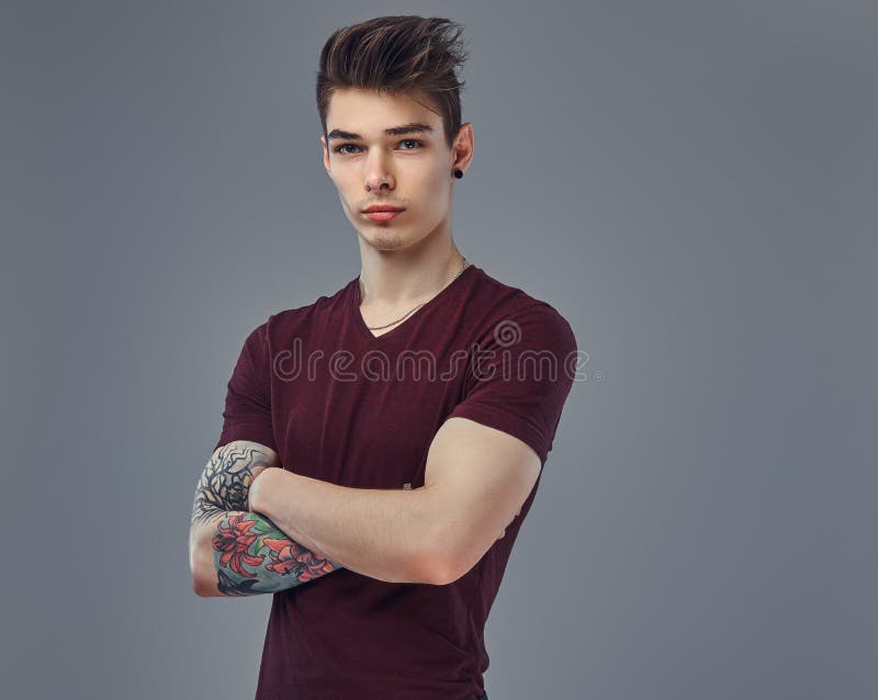 Handsome Fashionable Young Guy with Stylish Hair and Tattoo on His Arm Posing in a Studio. Stock Photo - Image of looking, hairstyle: 116549460 Handsome Fashionable Young Guy with Stylish Hair and Tattoo on His Arm Posing in a Studio. Stock Photo - Image of looking, hairstyle: 116549460