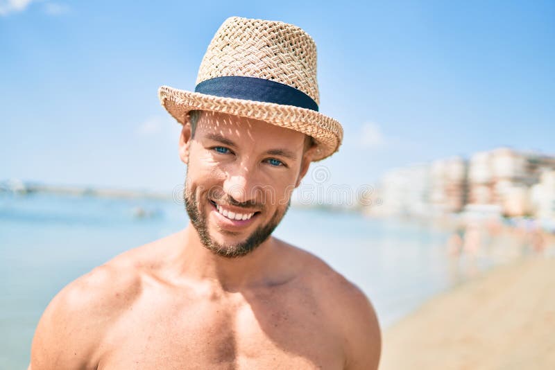 Handsome Fitness Caucasian Man At The Beach On A Sunny Day Wearing Summer Hat Stock Image 