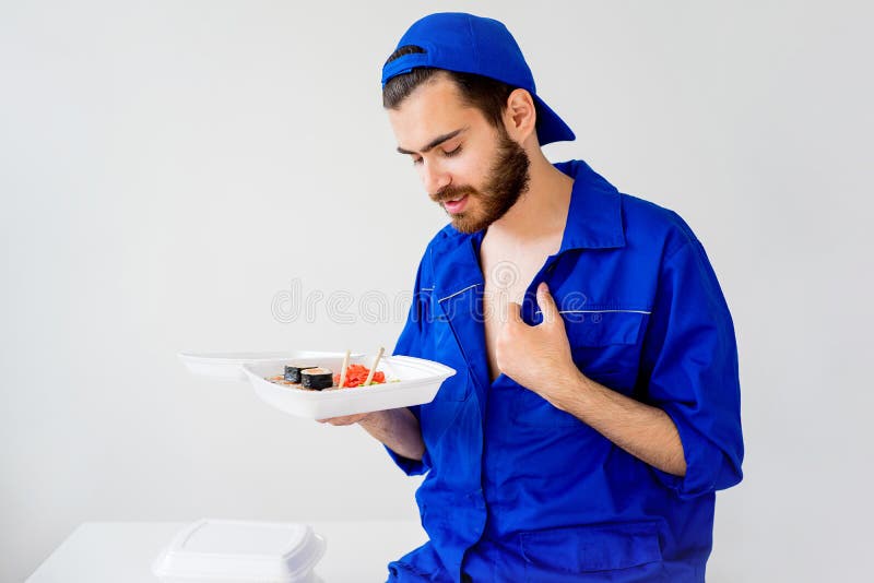 Handsome guy delivering sushi royalty free stock photo