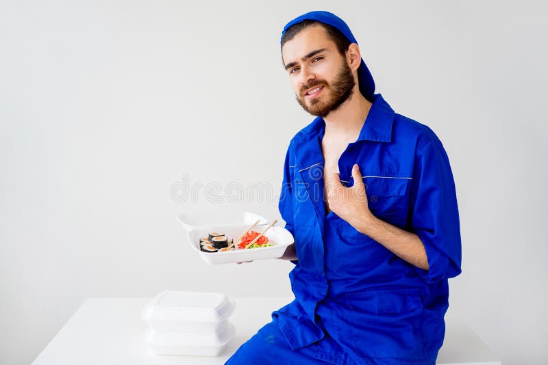 Handsome guy delivering sushi stock images