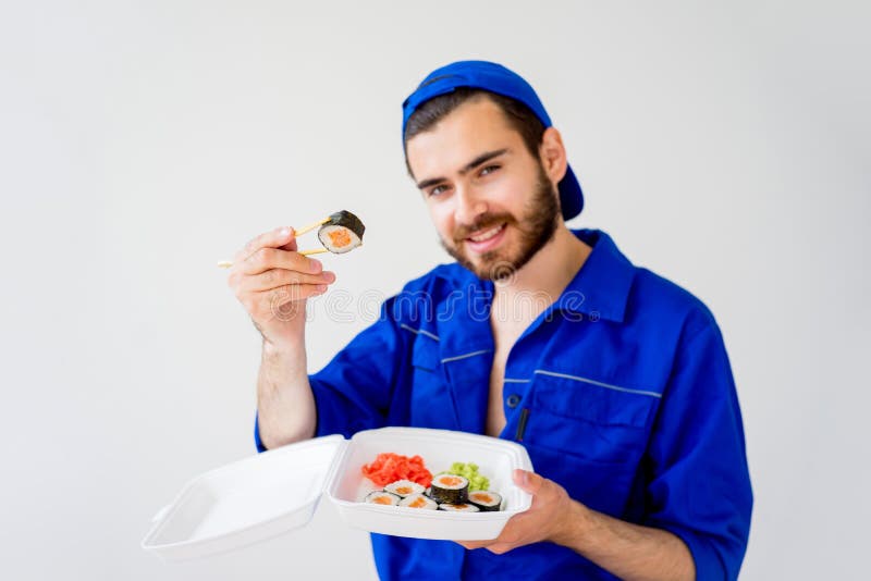 Handsome guy delivering sushi stock images