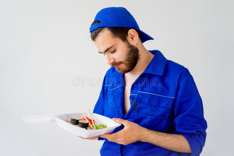 Handsome guy delivering sushi stock photography