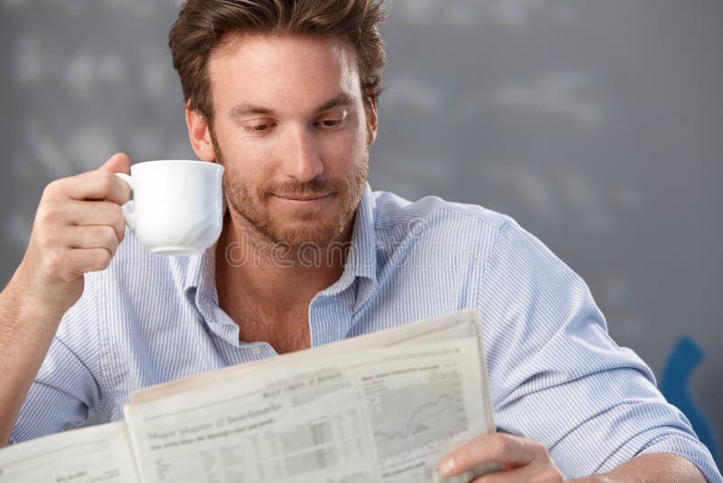Handsome guy with newspaper stock images Handsome guy with newspaper stock images