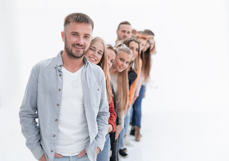 Handsome guy standing in front of a group of young people royalty free stock photo