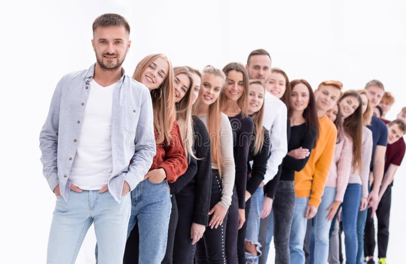 Handsome guy standing in front of a group of young people royalty free stock photo