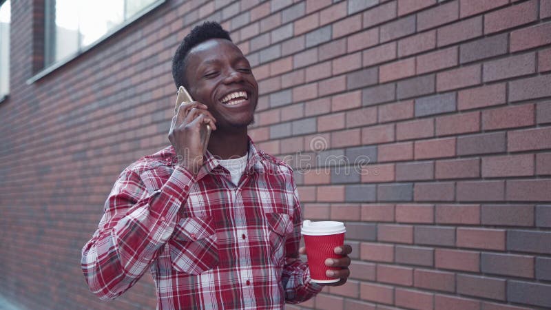 Handsome Happy Guy on His Cell Phone. Stock Image - Image of device