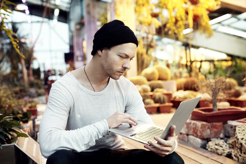 Handsome hipster man portrait working on start-up project on portable laptop computer. stock images Handsome hipster man portrait working on start-up project on portable laptop computer. stock images