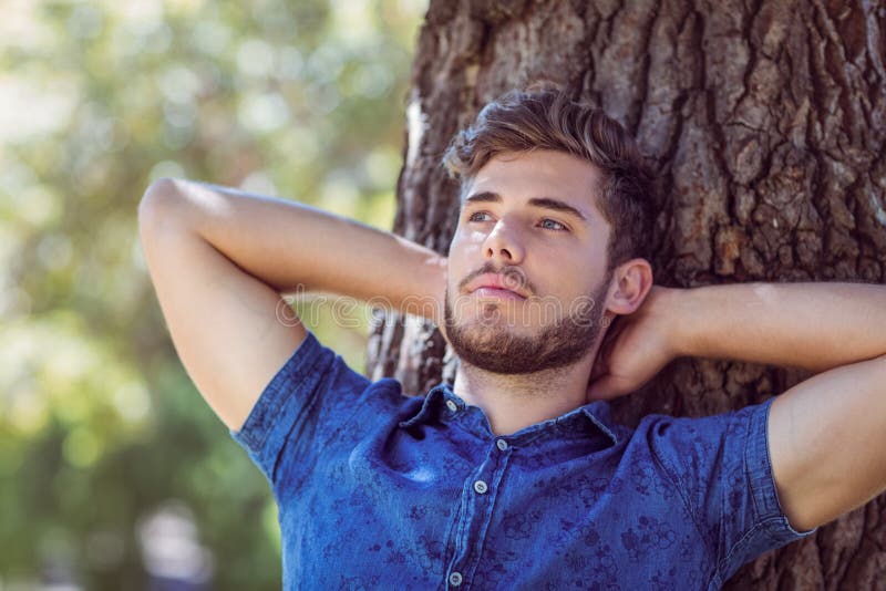 Handsome hipster relaxing in the park