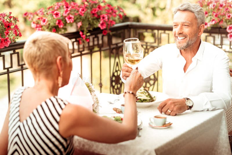 Handsome husband smiling having romantic date with wife