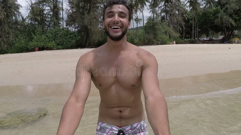 Handsome latin man walk on beach holding hand talking action camera pov of young couple on seaside