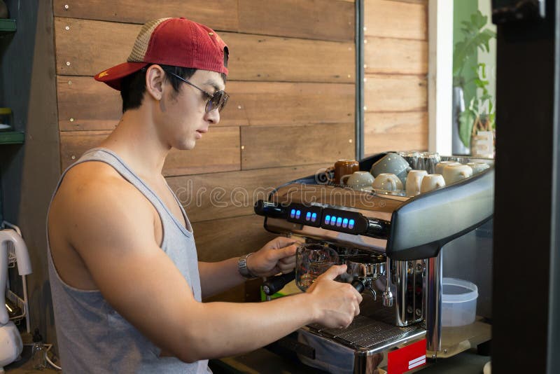Handsome man barista working make a coffee drink stock image