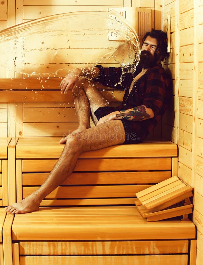 Splash of water on man on wooden background