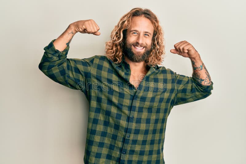 Handsome Man with Beard and Long Hair Wearing Casual Clothes Showing