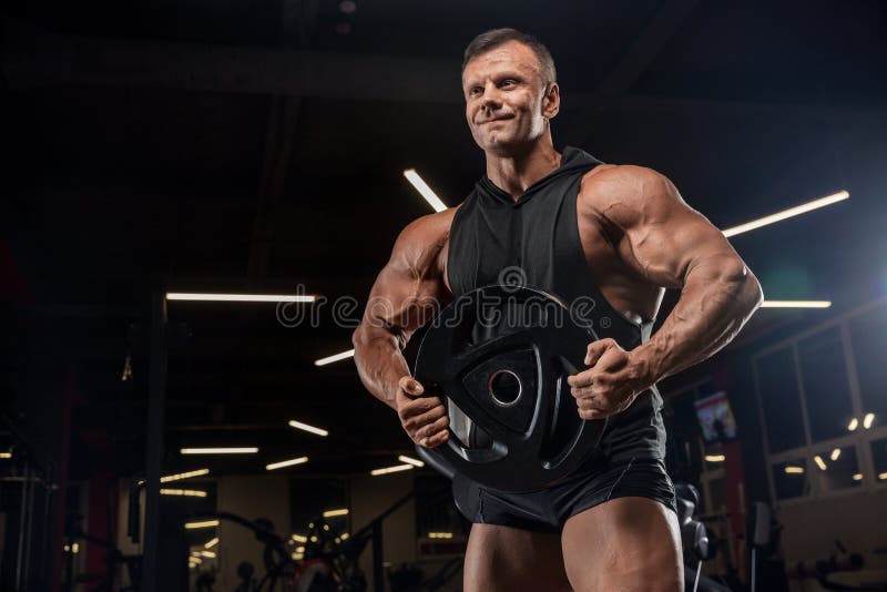 Muscular athletic bodybuilder fitness model posing after exercises in gym stock photos Muscular athletic bodybuilder fitness model posing after exercises in gym stock photos