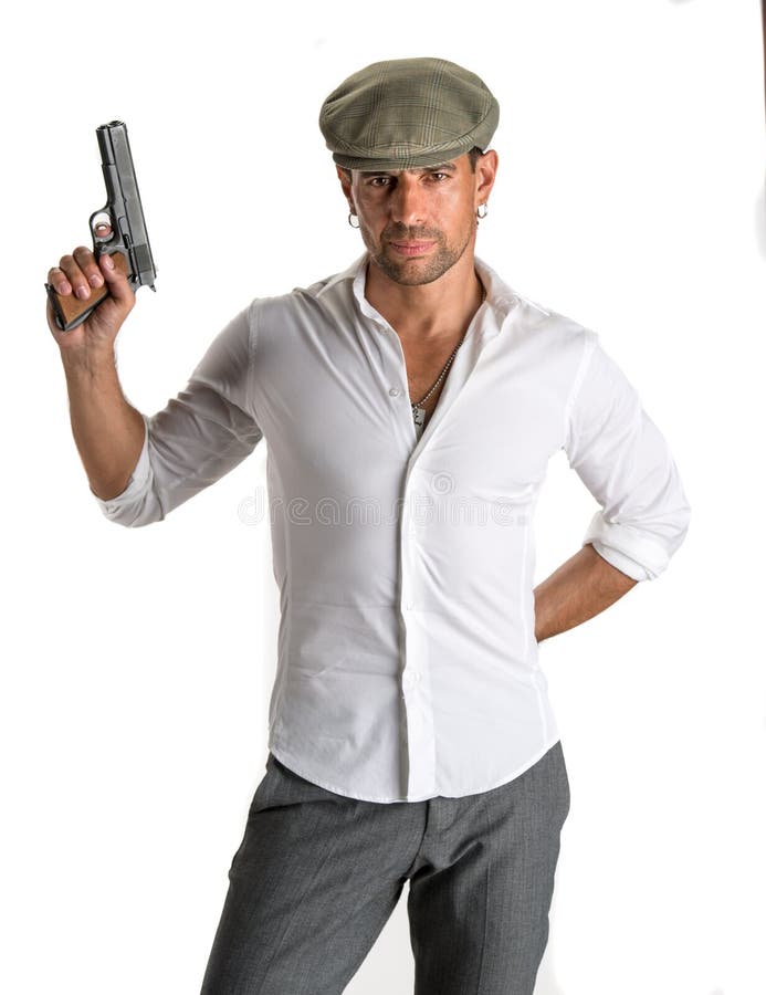 Handsome man in cap with a gun