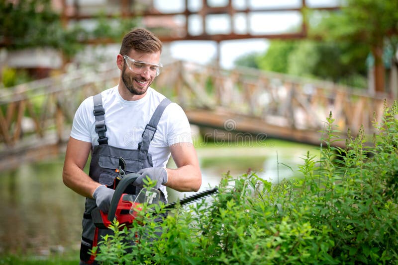 https://thumbs.dreamstime.com/b/handsome-man-dressed-gardening-outfit-trimming-bushes-168902033.jpg