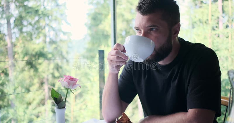 Thoughtful man drinking coffee at restaurant