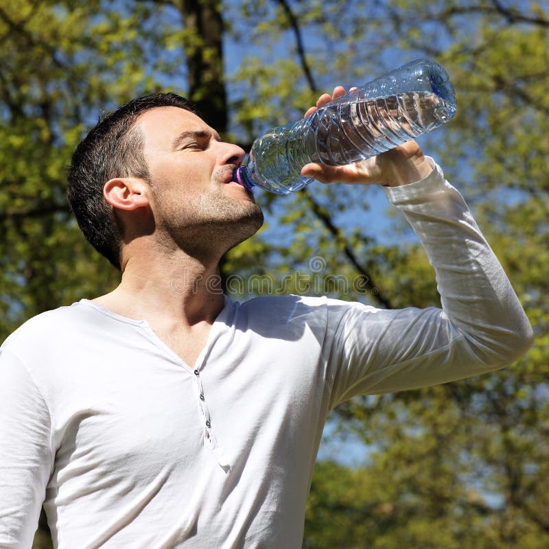 Handsome man drinking water