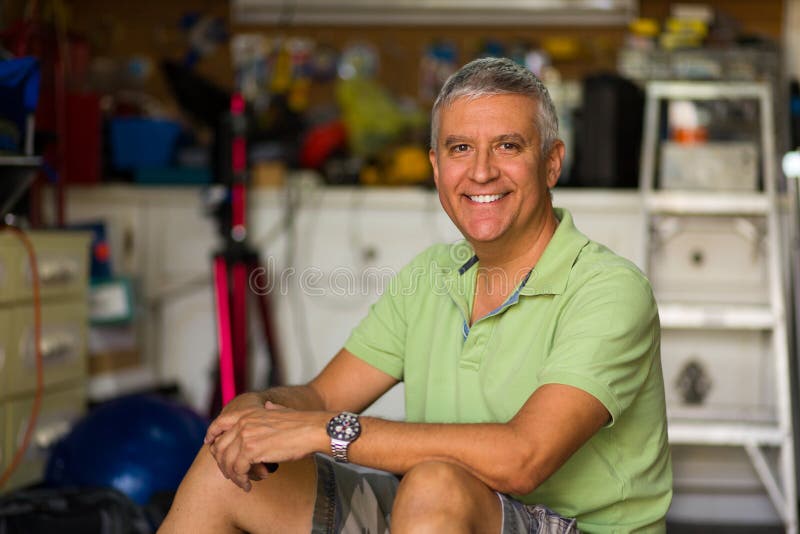 Handsome man in garage stock photography