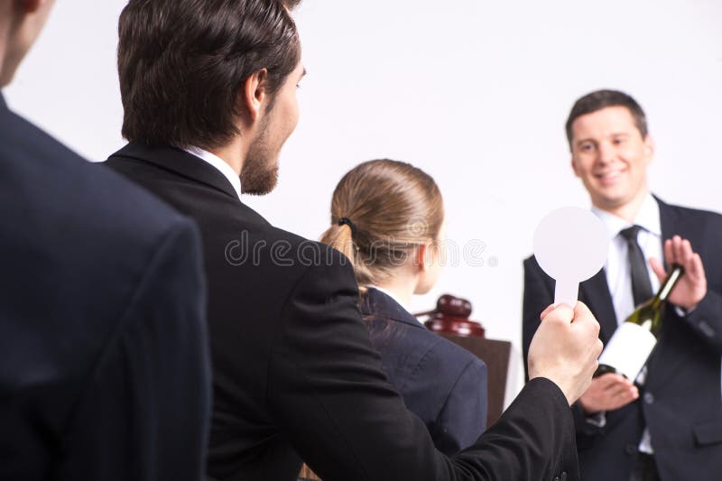 Handsome man holding bottle of wine. royalty free stock photography