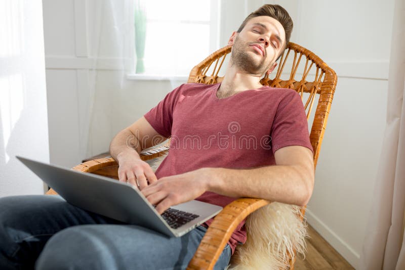 Handsome Man with Laptop Sleeping in Rocking Chair Stock Image Image