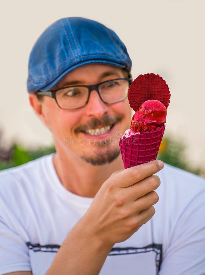 Handsome man is looking at an ice cream