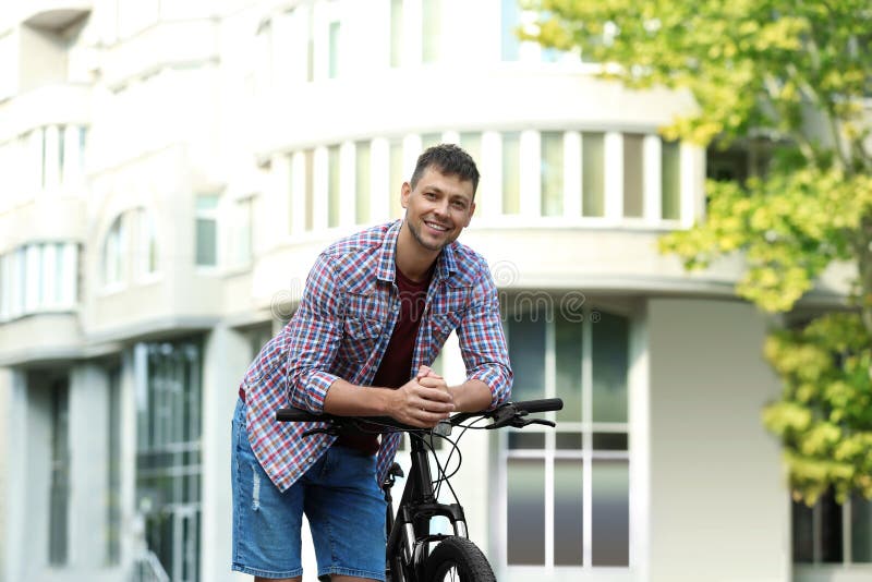 Handsome man with modern bicycle royalty free stock image Handsome man with modern bicycle royalty free stock image