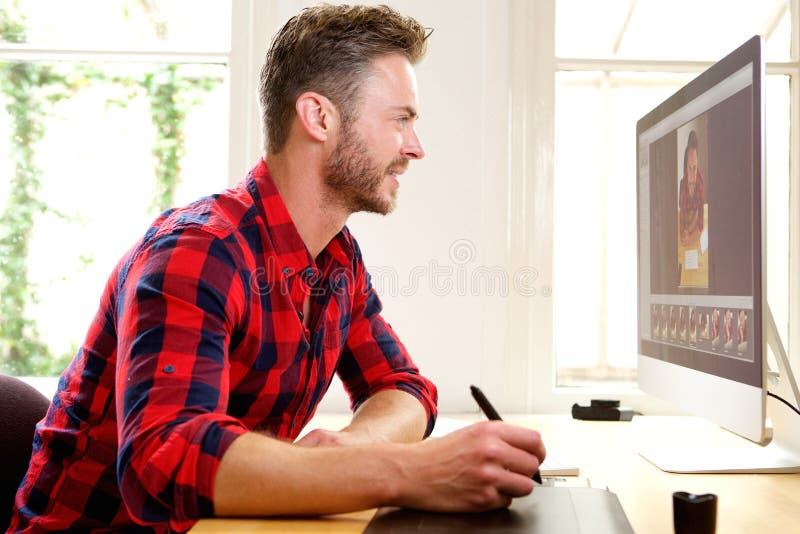 Side profile portrait of handsome man photo editing from home office. Computer editing stock images, royalty-free photos and pictures