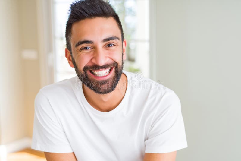 Handsome man smiling cheerful with a big smile on face showing teeth, positive and happy expression