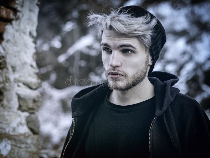 Portrait of young man in hoodie posing outdoor in winter setting with snow  all around, Stock Photo, Picture And Low Budget Royalty Free Image. Pic.  ESY-055233295 | agefotostock