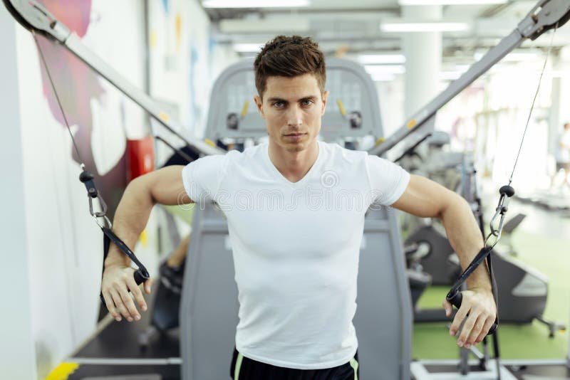 Handsome man training in clean modern gym