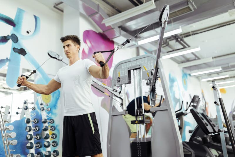 Handsome man training in clean modern gym