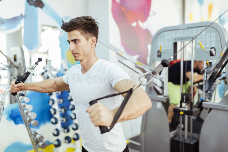 Handsome man training in clean modern gym